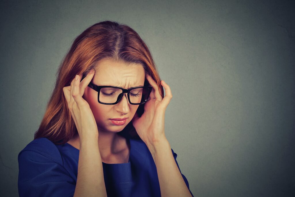 sad young woman in glasses with worried stressed face expression